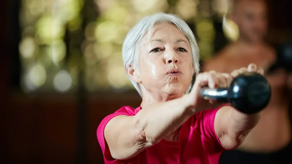 Toning Arms Without the Bulk: Is It Achievable? 1 Woman doing resistance band exercises for toned arms Wilmslow